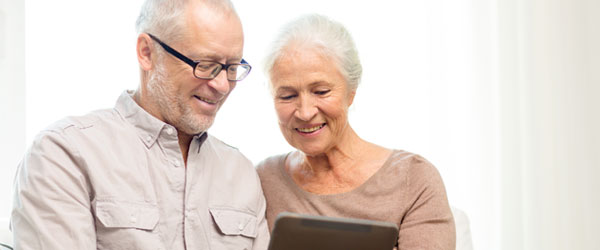 canadian senior couple with a tablet at home to know about reverse mortgage options and how it works