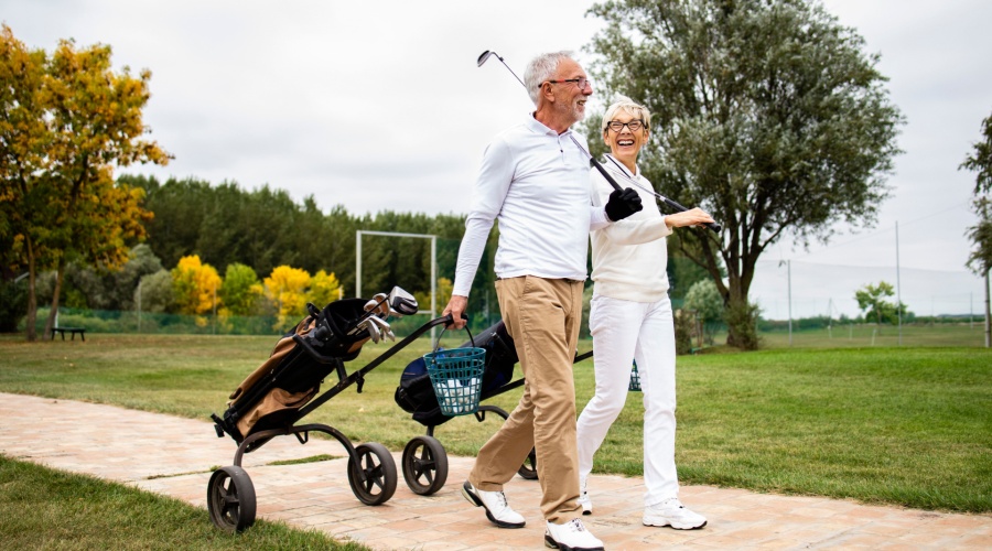 Elder couple playing golf