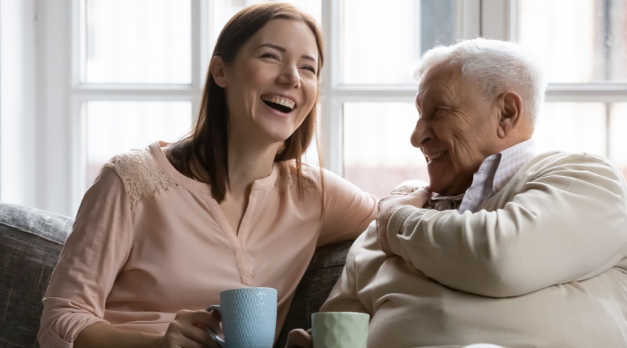 Elder man laughing with daughter
