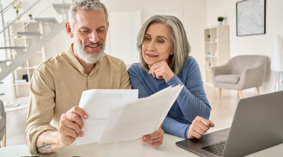Elderly-couple-looking-at-papers