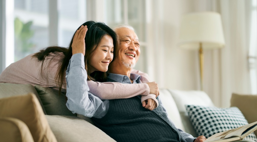 Father hugging his daughter in home