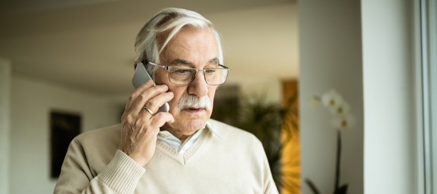 An older man talking on the his mobile phone