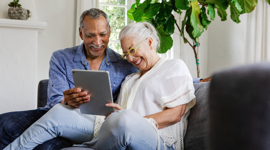 Happy old couple using digital technology