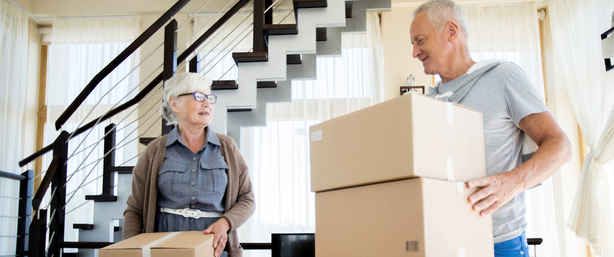 An older couple packing boxes