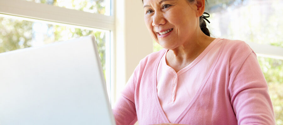 A senior woman working on laptop