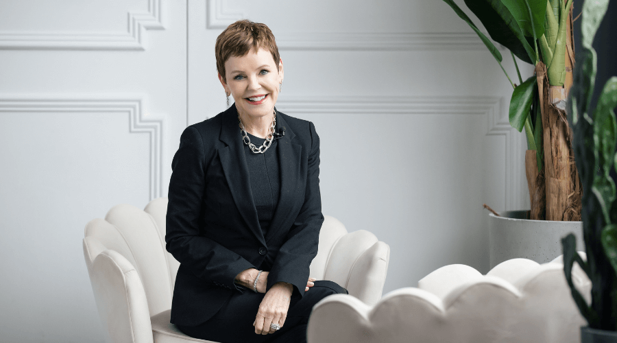 PLR-sitting-and-smiling-in-black-suit