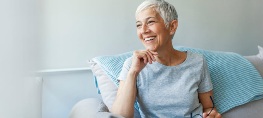 An older woman with short hair sitting on a couch