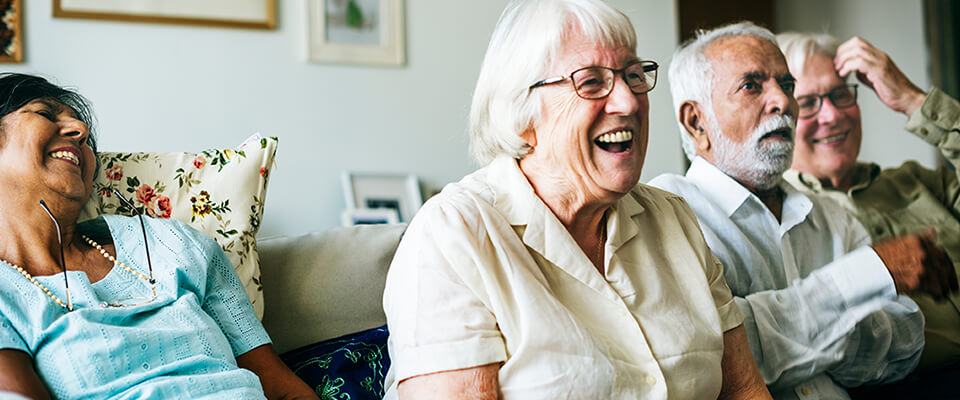 Seniors watching TV show together in Senior Housing Community after retirement in Canada.