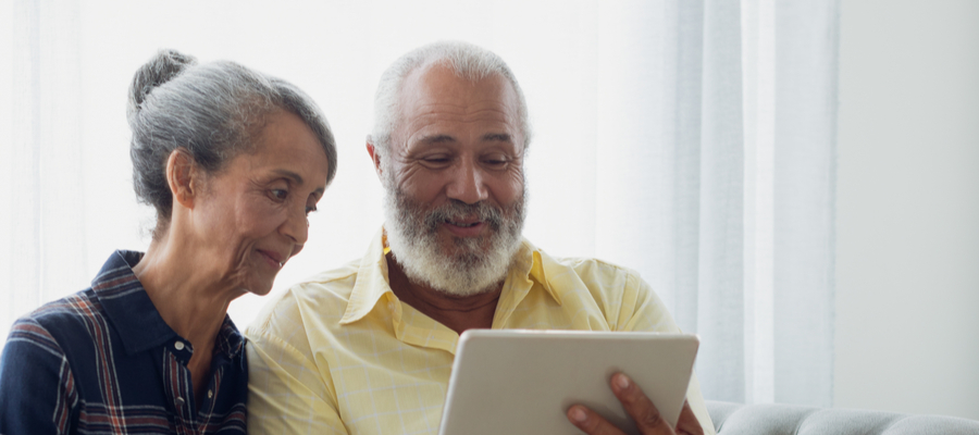 Older African couple looking at tablet together