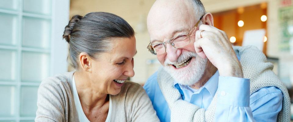 An older couple sitting together enjoying a moment together