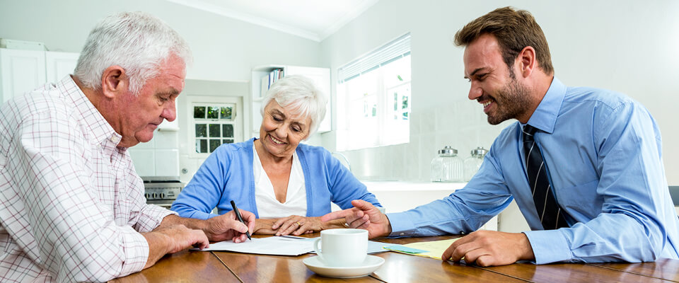 Senior homeowners calculating reverse mortgage costs.