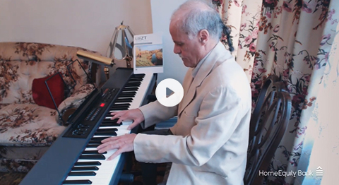 video image still of an older man playing an electronic keyboard