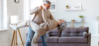 couple-dancing-in-living-room-laughing