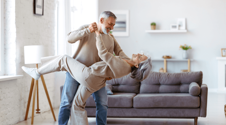 couple-dancing-in-living-room-laughing