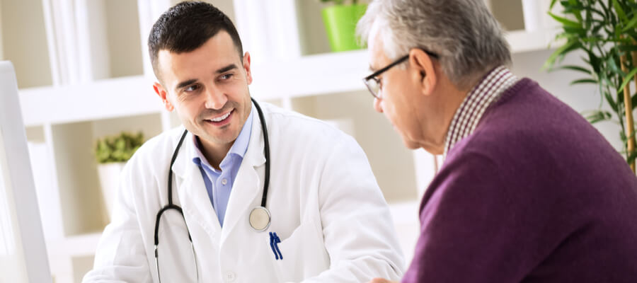 doctor-sitting-with-an-older-male-patient