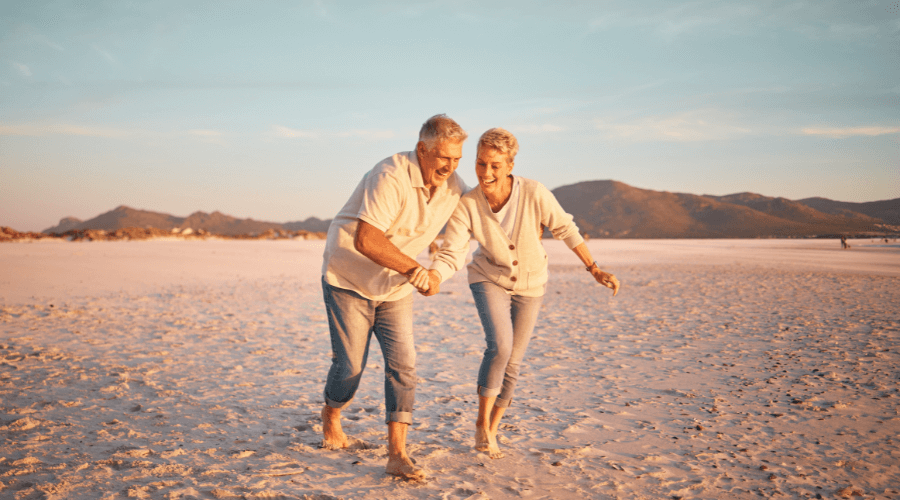 elderly-couple-having-fun-at-the-beach
