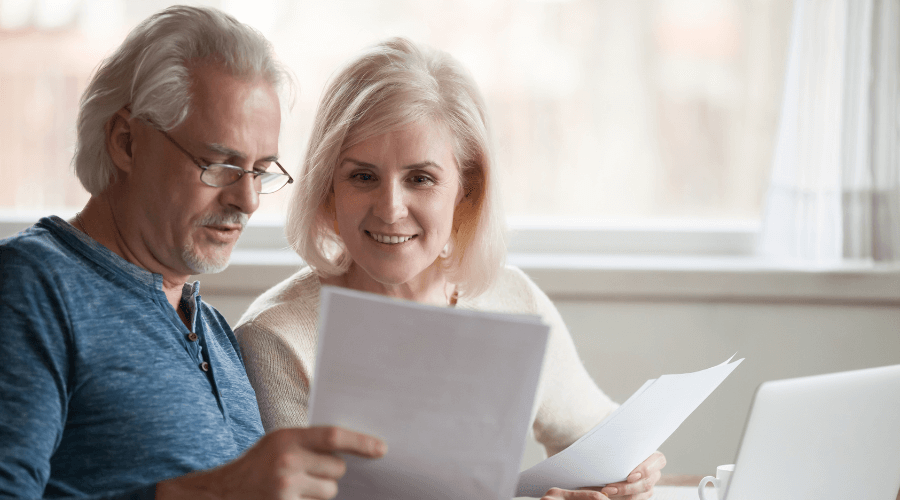 happy-middle-aged-couple-reviewing-their-investments