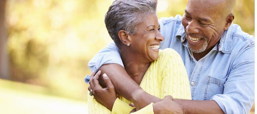 Middle age couple hugging and smiling at each other