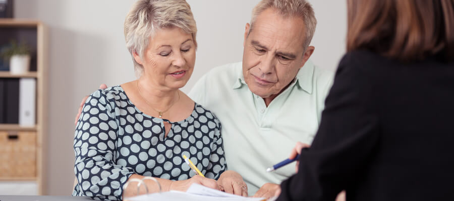 Middle aged couple going through the application process