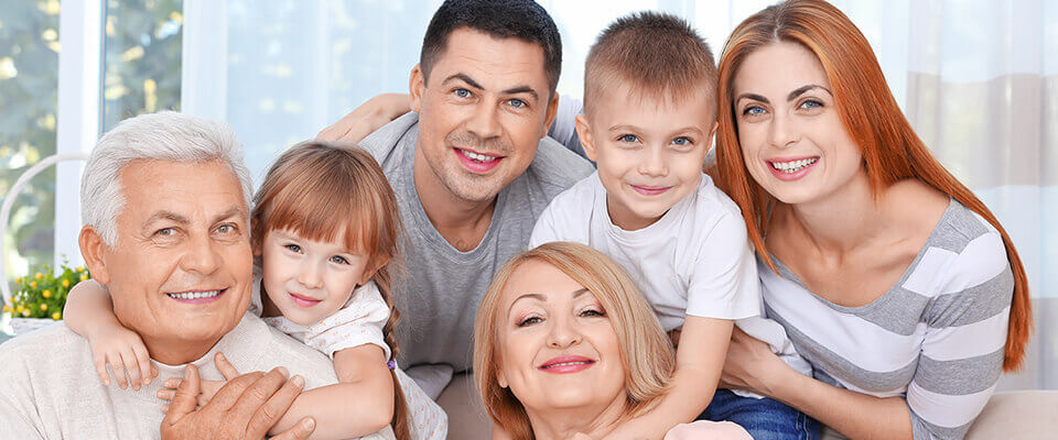 A family picture of a family of four with grandparents