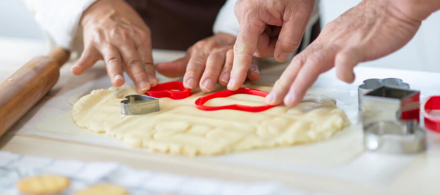 Senior couple hands making cookies