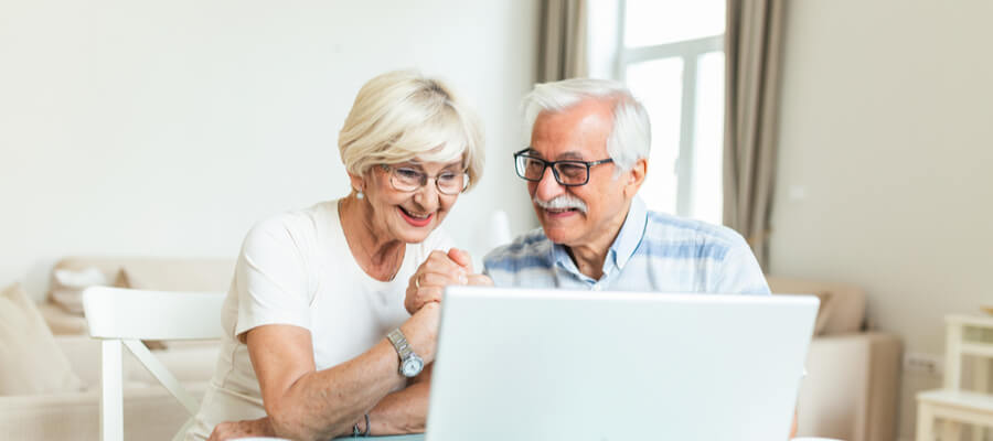 senior-couple-looking-at-finances-online