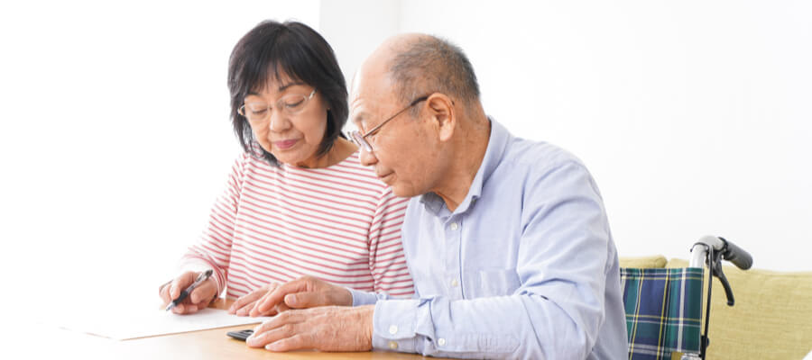 senior-couple-signing-line-of-credit-document