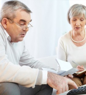 A Canadian senior couple using a reverse mortgage calculator to compute the loan amount due based on their home equity.