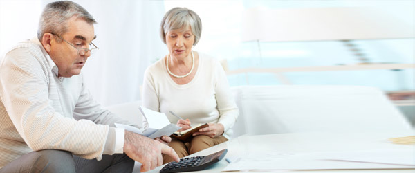 A Canadian senior couple using a reverse mortgage calculator to compute the loan amount due based on their home equity.