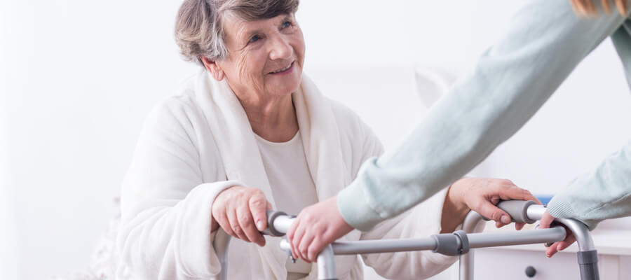 Senior lady using a walker disability