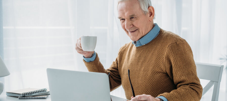 Senior man working on a laptop for RRIF withdrawal