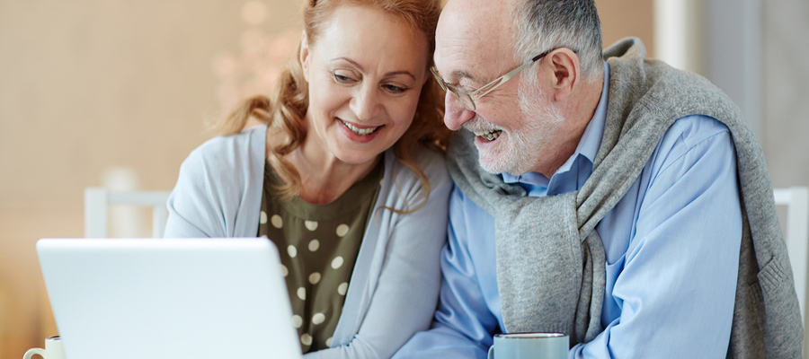 Senior smiling elderly couple video call