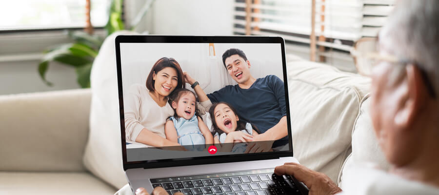 Older man talking to his family by video call