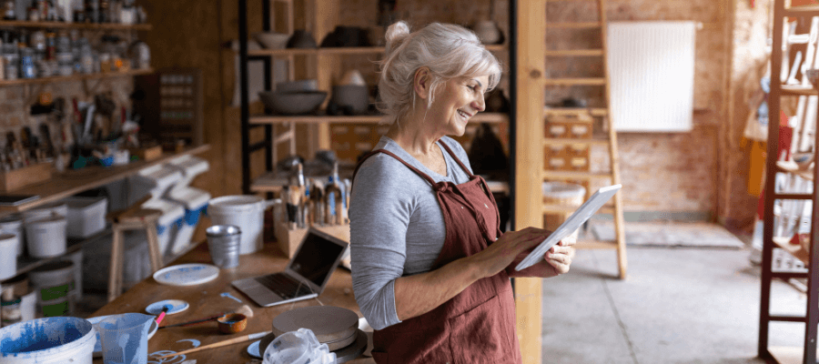 senior-woman-looking-at-the-an-ipad-and-smiling